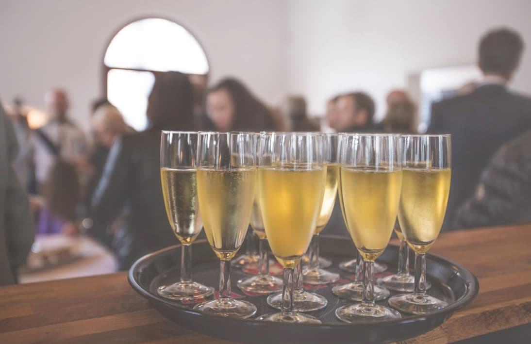 Champagne glasses on a tray at a social event