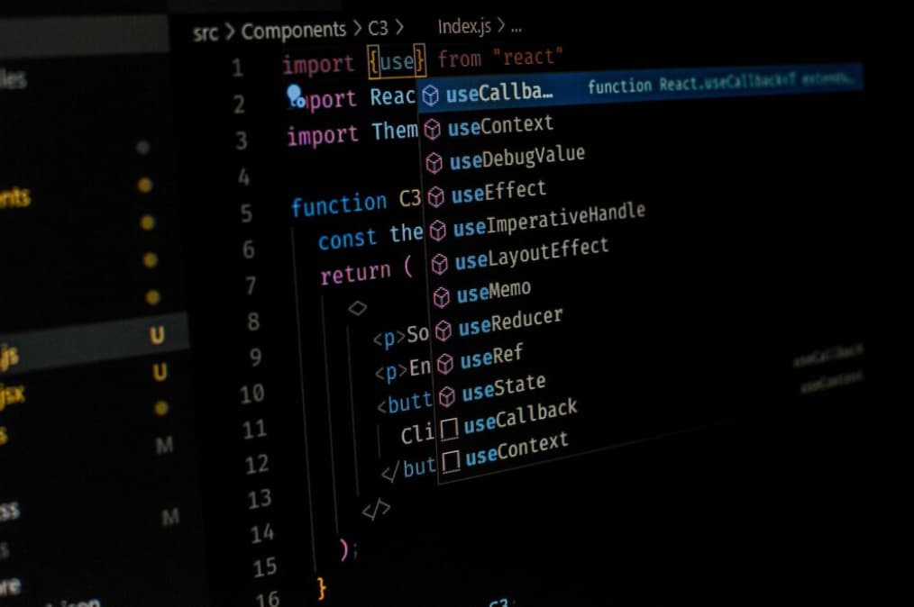 Close-up of a dark IDE screen with React code and autocompletion suggestions