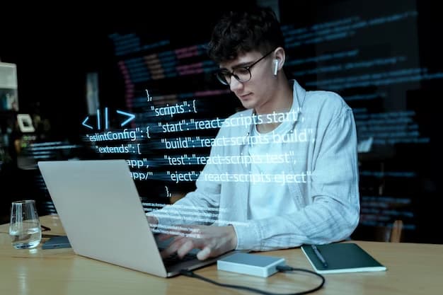 A man is working at his laptop and writing code