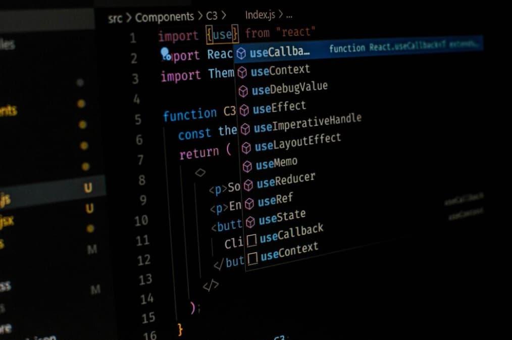 Close-up of a dark IDE screen with React code and autocompletion suggestions